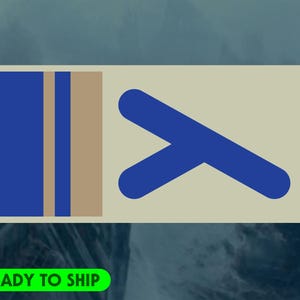 May include: A rectangular design with a light beige background. The left side features two vertical blue stripes and a tan stripe. The right side has a blue chevron shape. The text "READY TO SHIP" is in a green rectangle at the bottom.