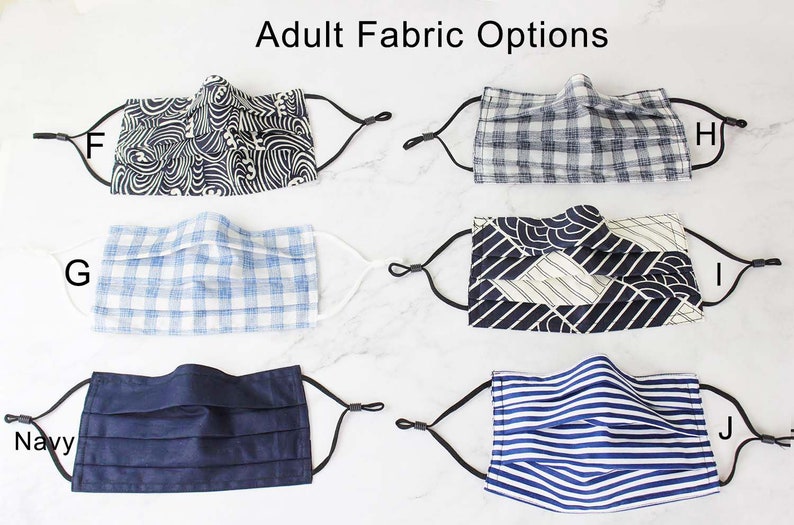 May include: Six different fabric options for face masks. The fabrics include a blue and white gingham, a navy blue solid, a blue and white stripe, a black and white geometric pattern, and two different blue and white wave patterns.