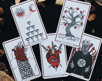 May include: Ten tarot cards with colorful illustrations and text. The cards include "The World", "King of Coins", "III of Daggers", "The Tower", and "X of Goblets".