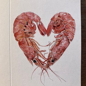 A close up of the image of 2 prawns curled round to form a heart, digitally reproduced on a small card.