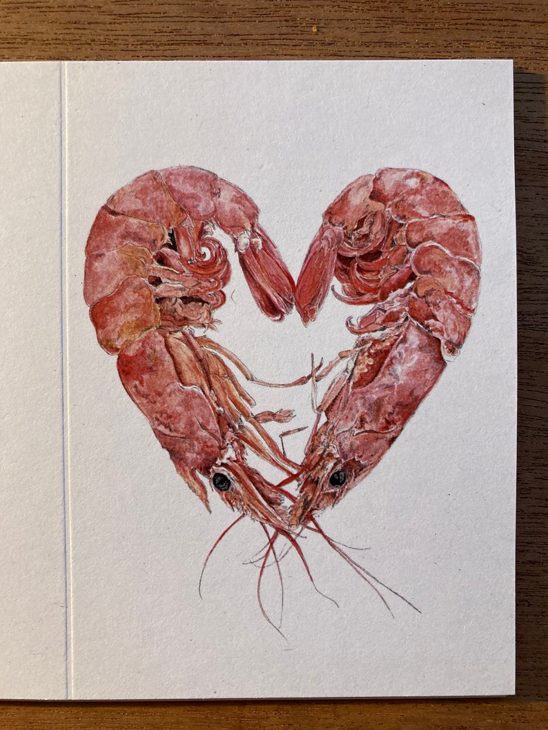 A close up of the image of 2 prawns curled round to form a heart, digitally reproduced on a small card.