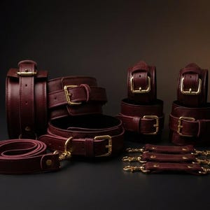Luxury burgundy leather BDSM bondage set gift box with cuffs, collar, spread bar and connectors, premium handmade bondage kit for couples anniversary or wedding gift.