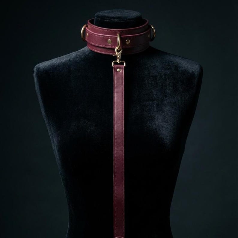 Elegant leather BDSM collar with leash displayed on mannequin, premium handcrafted bondage accessory for couples and intimate play.