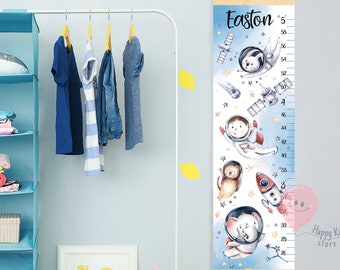 May include: A blue and white growth chart with a space theme. It features a rocket, stars, planets, and astronauts. The chart is personalized with the name "Easton" and has measurements in inches from 26 to 58 inches. The chart is made by Happy Kids store.