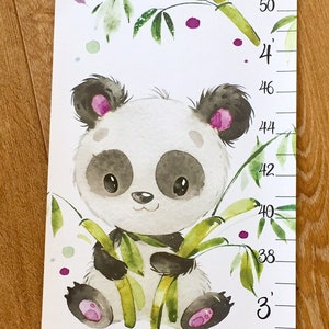 May include: A white growth chart with a panda bear design. The chart features three pandas holding bamboo stalks. The chart is labeled with the name "Violet" and has measurements in inches from 26 to 58.