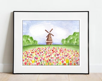 May include: Watercolor painting of a Dutch windmill in a field of colorful tulips. The artwork is framed in a black frame and set against a white wall. Green trees and a blue sky complete the scene.