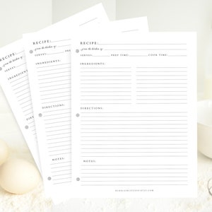 May include: Three blank recipe cards with lined spaces for writing down ingredients, directions, and notes. The cards have a simple design with a gray circle and text that says "RECIPE: from the kitchen of..."