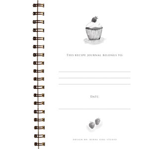 May include: A spiral-bound recipe journal with a watercolor illustration of a cupcake topped with a berry. The journal includes prompts for the owner's name and the date. The text "This recipe journal belongs to:" is printed at the top.