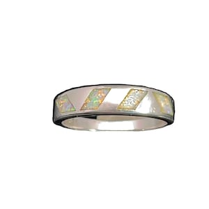 May include: A silver band ring with a white opal inlay design.
