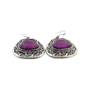 May include: A pair of silver earrings with a purple stone set in a filigree design.