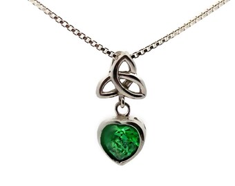 May include: A silver necklace with a Celtic knot pendant and a green heart-shaped gemstone.