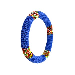 May include: A blue beaded bracelet with colorful accents. The bracelet is a solid blue color with sections of red, yellow, green, and white beads. The bracelet is a circular shape and is likely worn on the wrist.