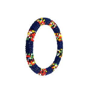 May include: A handcrafted beaded bracelet. The bracelet is primarily navy blue, with colorful accents of red, yellow, green, and white beads. The bracelet is circular and appears to be made of tightly woven beads.
