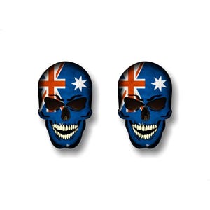 May include: Two skull stickers with the Australian flag design. The skulls are white with black eye sockets and a toothy grin. The Australian flag is blue with a white Union Jack in the upper left corner and a white star in the lower right corner.