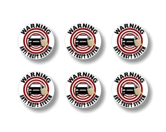 May include: Six circular stickers with a white background. Each sticker features a red concentric circle design with the words "WARNING" and "ANTI THEFT SYSTEM" in black. A black car silhouette and a tan paper bag are in the center.