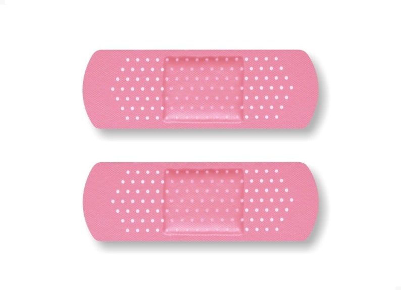 May include: Two pink adhesive bandages with white polka dots. The bandages are rectangular with rounded edges.