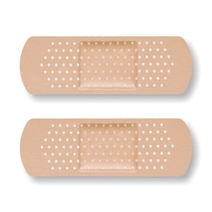 May include: Two beige adhesive bandages with white polka dots. The bandages have a rectangular adhesive pad in the center.
