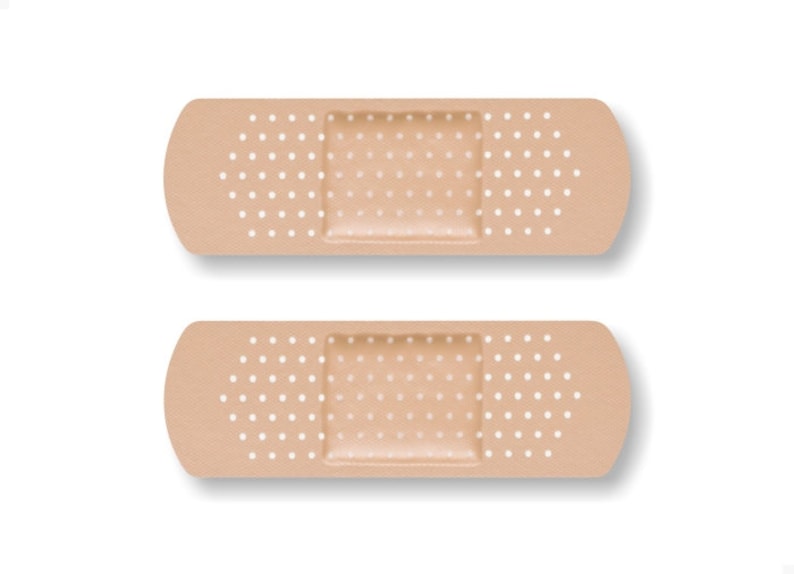 May include: Two beige adhesive bandages with white polka dots. The bandages have a rectangular adhesive pad in the center.