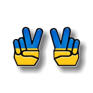 Op de afbeelding: Twee vredestekens in de kleuren van de Oekraïense vlag, blauw en geel.