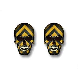 May include: Two black and yellow skull stickers with a chevron pattern. The skulls are grinning with white teeth.