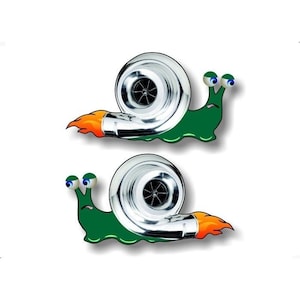 May include: Two green snail decals with a silver turbocharger shell and orange flames. The snails have blue eyes and a sad expression.