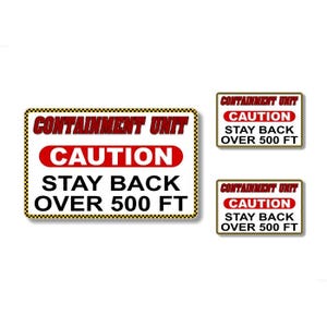 May include: Three white signs with black and yellow checkered borders. Each sign reads "CONTAINMENT UNIT" in black text, "CAUTION" in red text, and "STAY BACK OVER 500 FT" in black text.