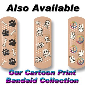 May include: Three cartoon printed band-aids. The first band-aid has a paw print and bone design. The second band-aid has a skull and crossbones design. The third band-aid has a peace sign and hand design. "Our Cartoon Print Band-aid Collection" is written below the band-aids.