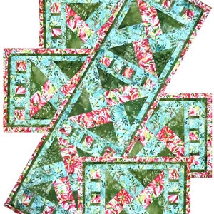 May include: Set of four green, pink, and blue quilted table runners with a floral pattern. The runners have a geometric design with a border of green and pink.