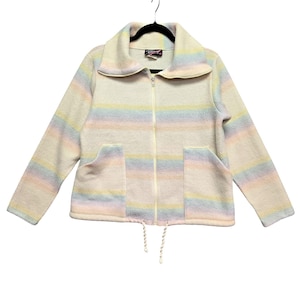 May include: A cream-colored fleece jacket featuring horizontal pastel rainbow stripes, a full-length front zipper, a wide collar, two front patch pockets, and a drawstring hem with white cords. The interior label displays the text "Morning Sun".