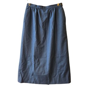 May include: A denim-coloured skirt with a button closure and a gathered waist. The skirt is knee-length and has a simple, classic design. The fabric appears to be a medium-weight material, suitable for various seasons.