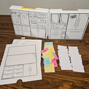 May include: A white cardboard play kitchen set with a refrigerator, oven, and cabinets. The set includes a variety of stickers and labels for decorating. The set is designed for children to play pretend.