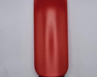 May include: A red plastic bottle with a black cap and a handle on the top. The bottle is empty.