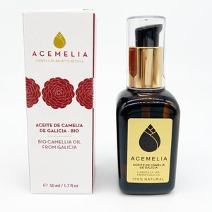 May include: A 50 ml bottle of 100% natural camellia oil from Galicia, Spain. The bottle is clear glass with a gold pump top and a gold label with the brand name Acemelia and the text "Aceite de Camelia de Galicia - Bio Camellia Oil from Galicia 100% Natural".