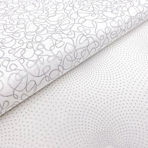 Könnte beinhalten: Zwei weiße Stoffmuster mit silbernen Mustern. Ein Muster hat ein wirbelndes, abstraktes Design. Das andere Muster hat ein sich wiederholendes Muster aus kleinen silbernen Punkten.
