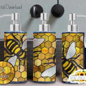 May include: Three yellow and black bee soap dispensers with a stained glass design. The dispensers are on a grey countertop with a white sink in the background.