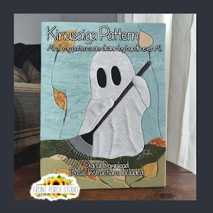 May include: A Kinusaiga pattern digital download featuring a white ghost holding a rake, surrounded by autumn leaves on a light blue background. The text reads: Kinusaiga Pattern, All of my patterns are drawn by hand, never AI, Digital Download, Basic Instructions Included.
