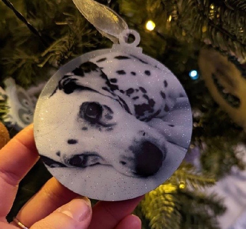 May include: A white and black dalmatian dog ornament with glitter, perfect for a Christmas tree.