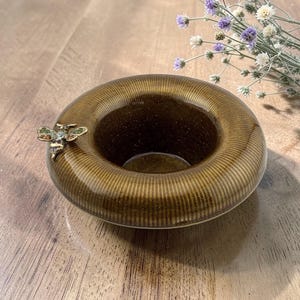 May include: A set of three ceramic mugs with a speckled, matte finish. Each mug features a different color: light blue, cream, and gray. The mugs have a simple, modern design and a comfortable handle.