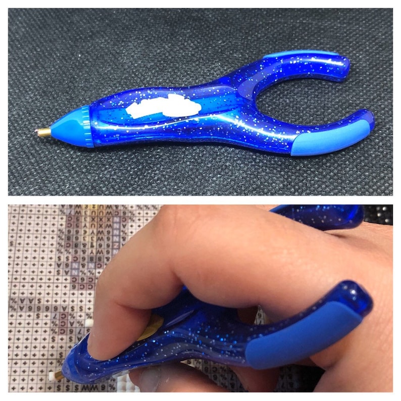 May include: Blue diamond painting pen with a clear plastic body and a blue rubber grip. The pen has a small metal tip for picking up diamonds.