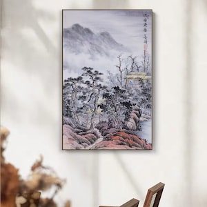 May include: A framed painting of a misty mountain landscape with a small village in the foreground. The painting is in shades of gray, blue, and pink, with a few touches of green. The text "竹田 庄司" is written in the upper right corner of the painting.
