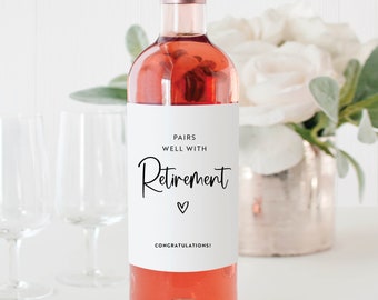 May include: A white wine bottle label with black text that reads "Pairs well with Retirement" with a small heart symbol and the text "Congratulations!" at the bottom.