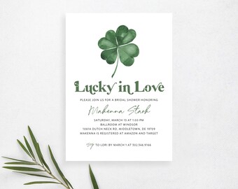 May include: A white bridal shower invitation with a green four-leaf clover illustration. The text reads "Lucky in Love" and includes the bride's name, date, time, location, and RSVP information.