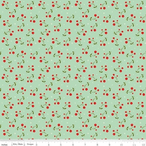 May include: A fabric with a repeating pattern of red cherries on green stems, scattered across a light green background. The design includes small white floral accents. The fabric is measured in inches.
