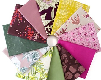May include: A circular arrangement of fabric swatches in various colors and patterns. The fabrics include floral, geometric, and solid designs in shades of pink, green, yellow, and brown. A white, spherical object is in the center.