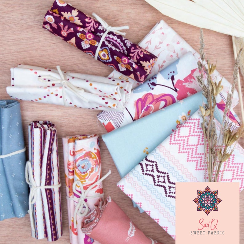 May include: An assortment of colorful fabric bundles and individual fabric pieces. The fabrics feature floral, geometric, and patterned designs in shades of pink, blue, purple, and white. Some bundles are tied with white string. The Suzi Q Sweet Fabric logo is in the bottom right corner.