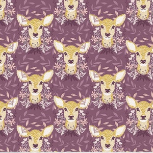 May include: A repeating pattern of deer faces with floral accents on a deep purple background. The deer are a golden yellow color with white ears and are surrounded by a wreath of flowers and leaves. The overall design is whimsical and nature-themed.