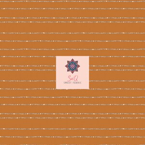 May include: A fabric with a repeating pattern of horizontal, rust-colored stripes. Each stripe is accented with a dotted white line. The fabric features a logo with a floral design and the text "Suzi Q SWEET FABRIC".