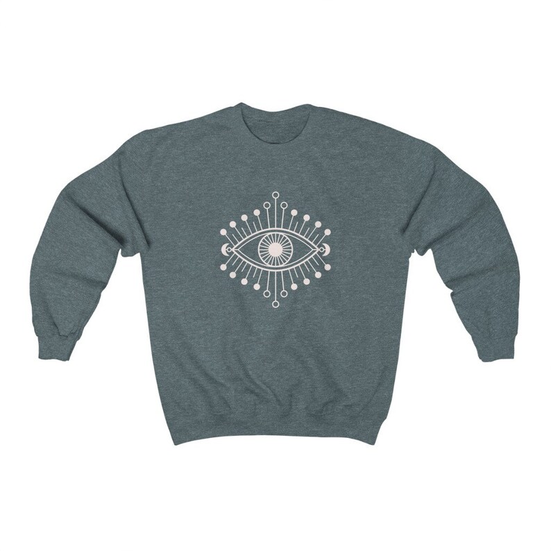 May include: A dark blue sweatshirt with a white graphic of a stylized eye with radiating lines and crescent moons.