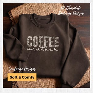 May include: A brown sweatshirt with the text "COFFEE weather" in white with a leopard print design. The sweatshirt is soft and comfy.