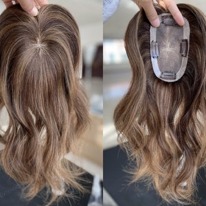 May include: A brown and blonde hair topper with a clip-in base. The topper is designed to add volume and coverage to thinning hair.